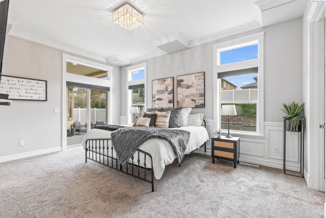 carpeted bedroom featuring a decorative wall, a wainscoted wall, crown molding, and access to outside
