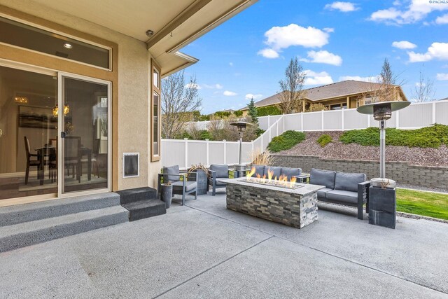 view of patio with a fenced backyard and an outdoor living space with a fire pit