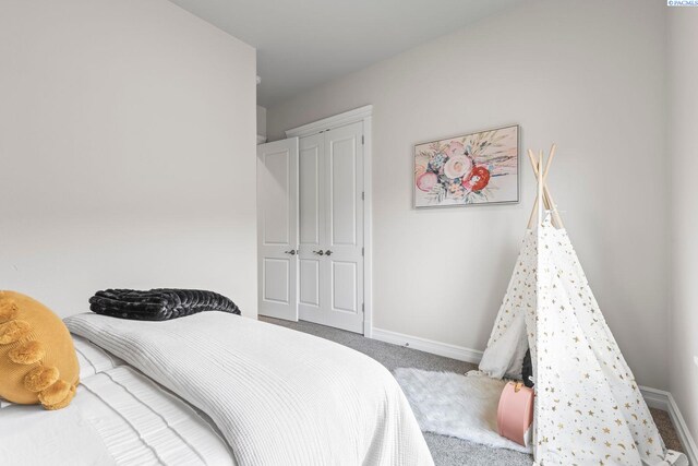 bedroom featuring carpet floors and baseboards