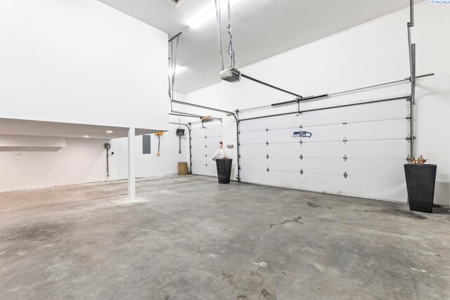 garage featuring electric panel and a garage door opener