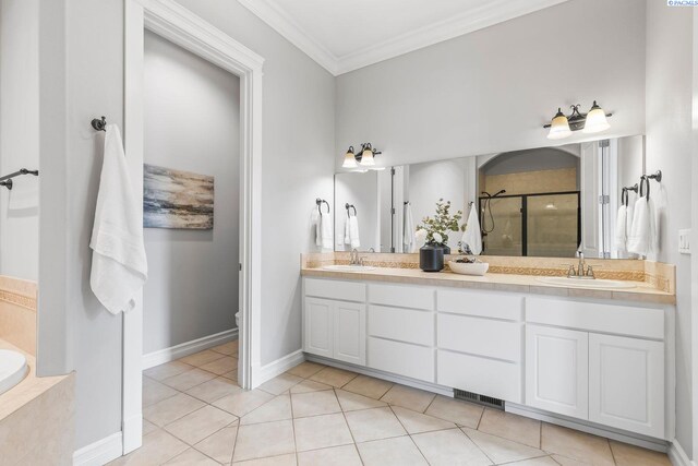 full bath featuring a stall shower, tile patterned floors, a sink, ornamental molding, and double vanity
