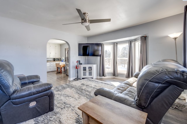 living room featuring ceiling fan and light hardwood / wood-style floors