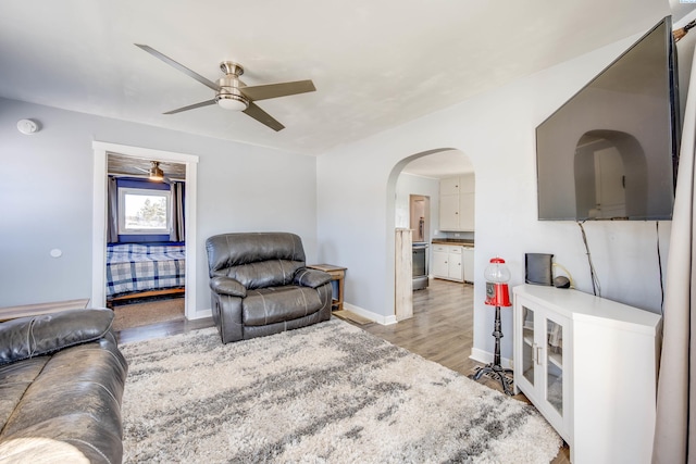 living room featuring ceiling fan and light wood-type flooring