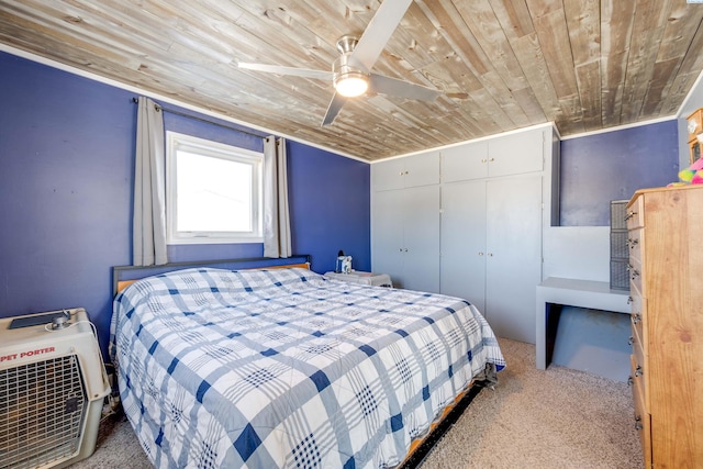 carpeted bedroom featuring ceiling fan, wood ceiling, and a closet