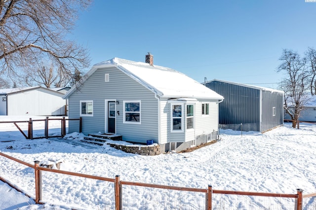 view of snow covered back of property