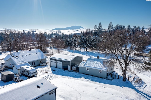 snowy aerial view with a mountain view