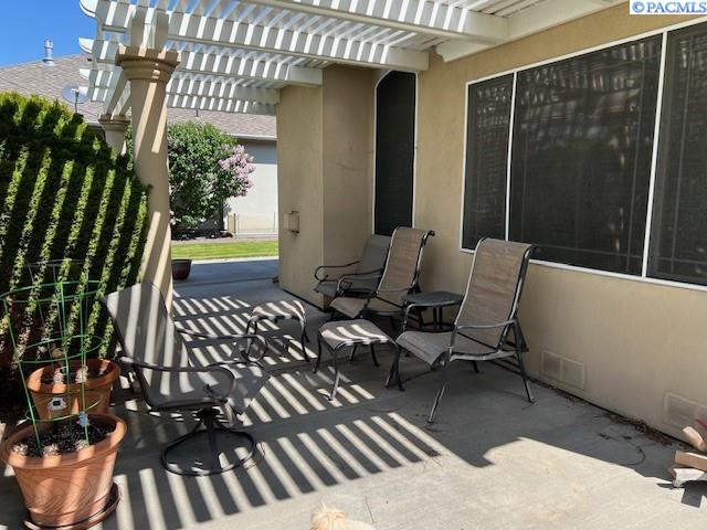 view of patio with a pergola and visible vents