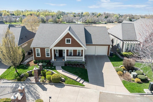 1016 SE Crestlane Dr, College Place, WA 99324 - view of front of property with a garage, a porch, roof with shingles, concrete driveway, and a residential view