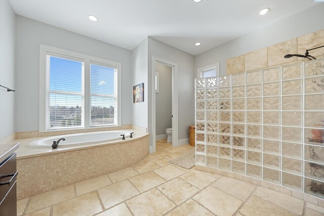 1016 SE Crestlane Dr, College Place, WA 99324 - bathroom featuring stone tile flooring, toilet, a tile shower, recessed lighting, and a garden tub