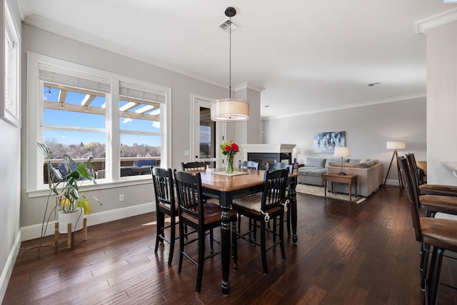 1016 SE Crestlane Dr, College Place, WA 99324 - dining area with a fireplace, baseboards, crown molding, and dark wood finished floors