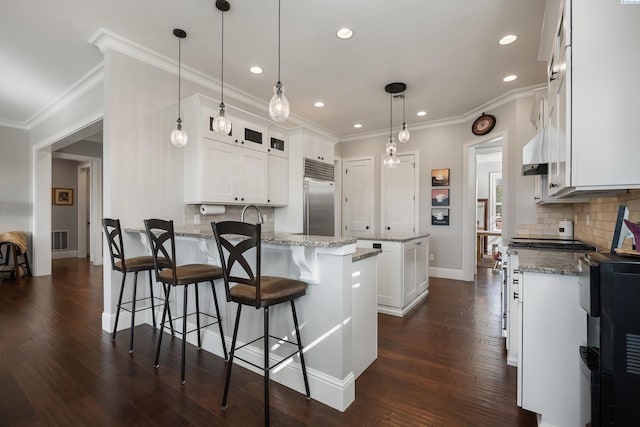 1016 SE Crestlane Dr, College Place, WA 99324 - kitchen with visible vents, stainless steel built in fridge, a peninsula, dark wood finished floors, and white cabinetry