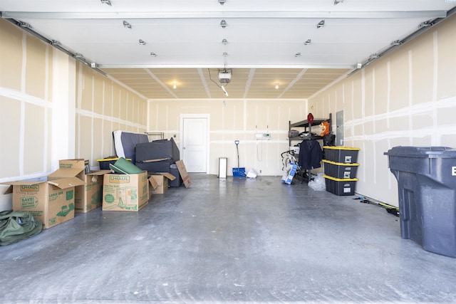 garage with electric panel and a garage door opener
