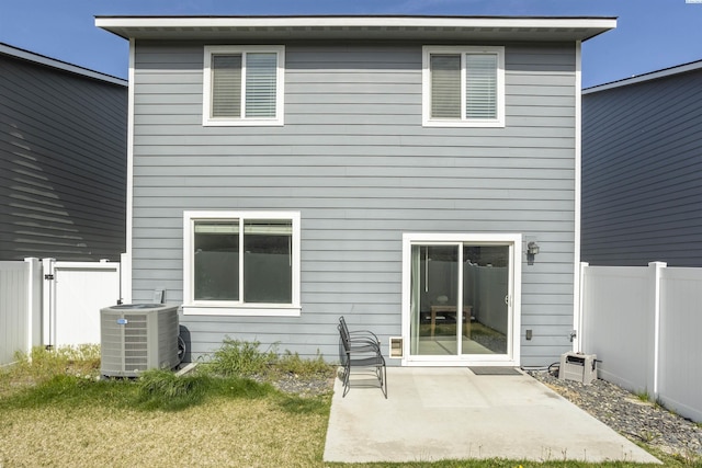 back of property featuring a patio, central AC, fence, and a yard