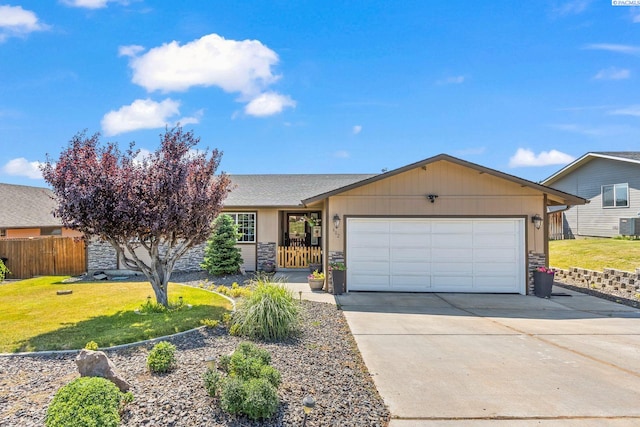 602 N 57th St, Yakima, WA 98901 - ranch-style house with stone siding, a garage, and concrete driveway