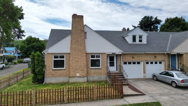 201 W Cooper St, Colfax, WA 99111 - view of front of property featuring brick siding, driveway, a chimney, and an attached garage