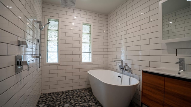 201 W Cooper St, Colfax, WA 99111 - full bathroom with tile walls, a freestanding tub, vanity, and tiled shower