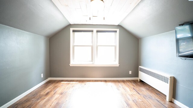 201 W Cooper St, Colfax, WA 99111 - bonus room featuring radiator, wood finished floors, vaulted ceiling, and baseboards