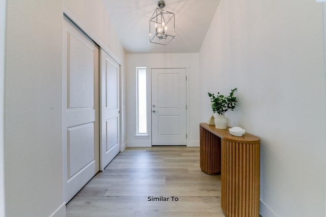 entryway featuring a chandelier and light hardwood / wood-style floors