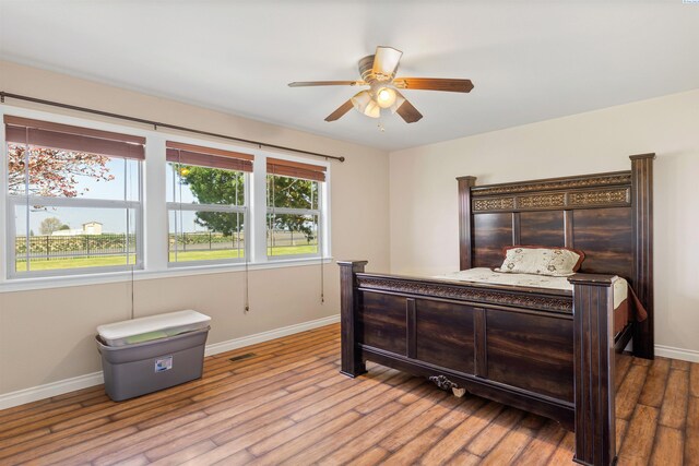 bedroom with ceiling fan and light hardwood / wood-style floors