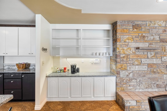 kitchen with light stone counters and white cabinets