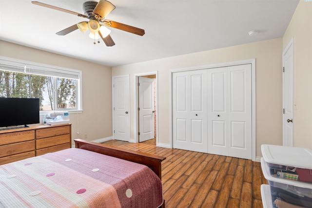 bedroom with hardwood / wood-style floors, a closet, and ceiling fan