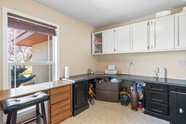 home office featuring built in desk and plenty of natural light