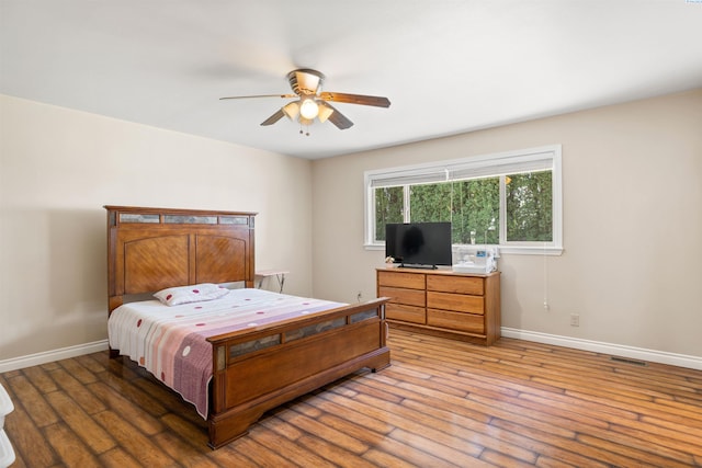 bedroom with hardwood / wood-style floors and ceiling fan