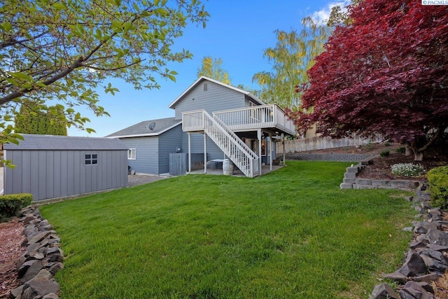 3715 Meadow Beauty Dr, Pasco, WA 99301 - rear view of property with stairway, a wooden deck, an outbuilding, a yard, and a storage unit