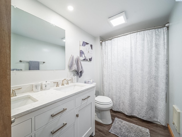 3680 E Euclid Rd, Mabton, WA 98935 - bathroom with wood finished floors, toilet, double vanity, and a shower with shower curtain