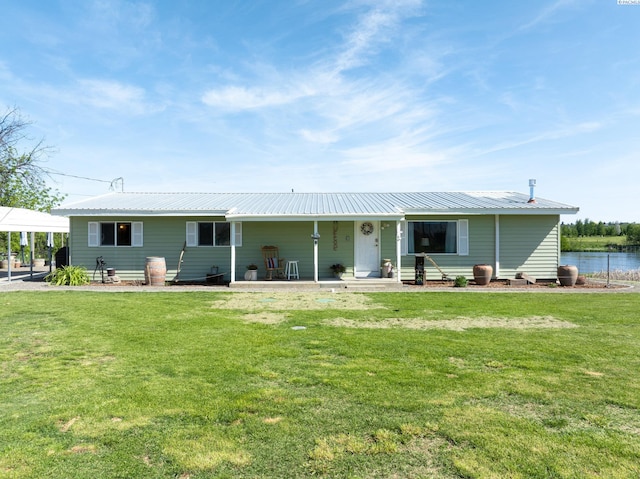 3680 E Euclid Rd, Mabton, WA 98935 - back of house with a lawn, metal roof, a detached carport, and a water view