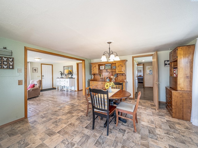 3680 E Euclid Rd, Mabton, WA 98935 - dining space with a chandelier and baseboards