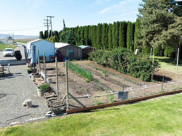 3680 E Euclid Rd, Mabton, WA 98935 - view of grassy yard featuring a garden, an outdoor structure, and an outbuilding