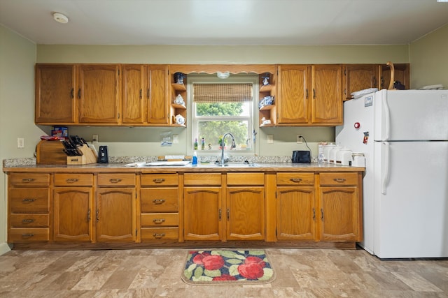 kitchen with sink and white fridge