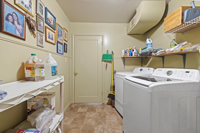 clothes washing area with washing machine and dryer