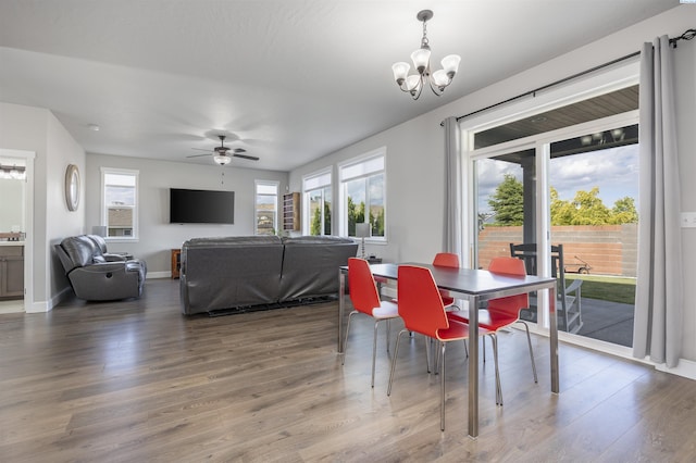 3303 S Taft St, Kennewick, WA 99338 - dining area featuring wood finished floors, a chandelier, a ceiling fan, and baseboards