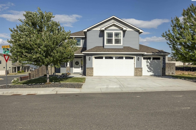 3303 S Taft St, Kennewick, WA 99338 - view of front facade with driveway, roof with shingles, stone siding, and an attached garage