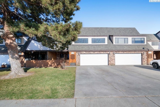 view of front of home with a garage and a front lawn