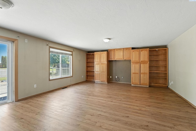 4505 S Dayton Ct, Kennewick, WA 99337 - unfurnished living room featuring light wood finished floors and a textured ceiling