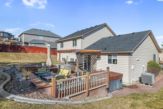 rear view of house featuring a shingled roof, fence, a pergola, and cooling unit