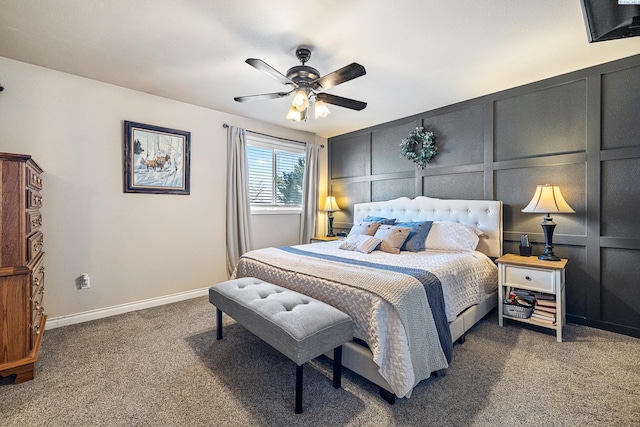 bedroom featuring carpet floors, baseboards, a decorative wall, and a ceiling fan