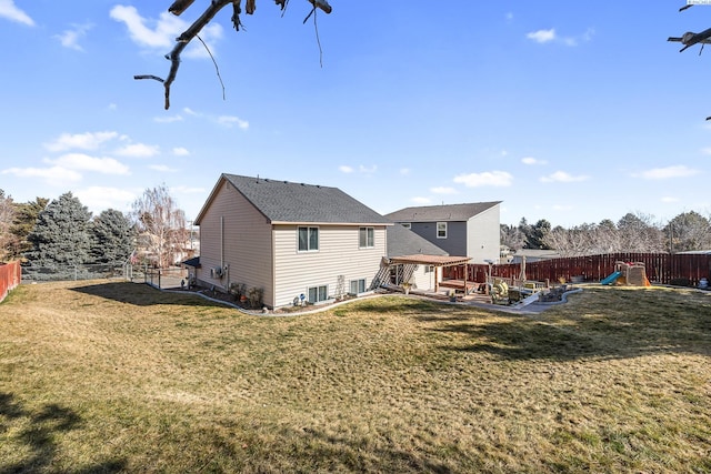 back of property featuring a playground, a yard, a patio area, and a fenced backyard