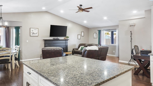 kitchen featuring dark stone countertops, pendant lighting, white cabinets, and dark hardwood / wood-style flooring