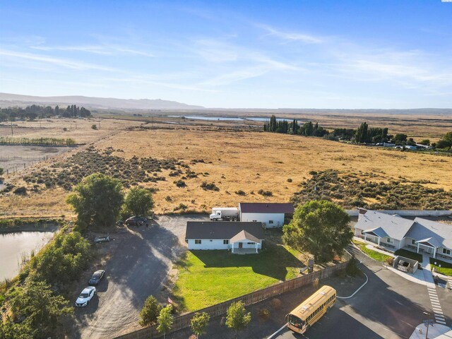 aerial view featuring a rural view and a water and mountain view