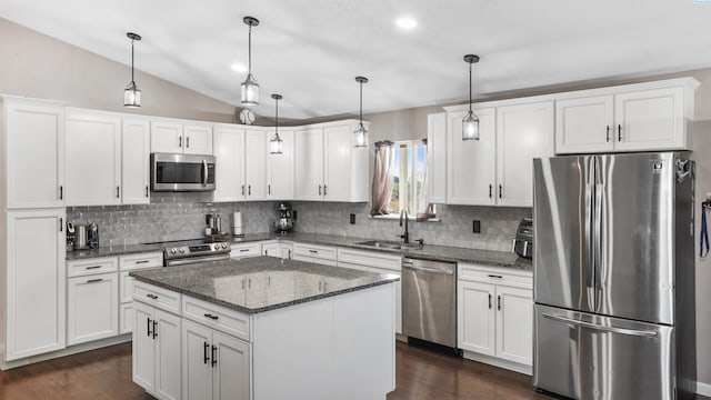 kitchen featuring sink, decorative light fixtures, appliances with stainless steel finishes, a kitchen island, and white cabinets