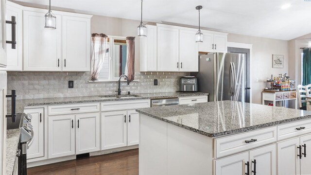 kitchen featuring appliances with stainless steel finishes, sink, and white cabinets