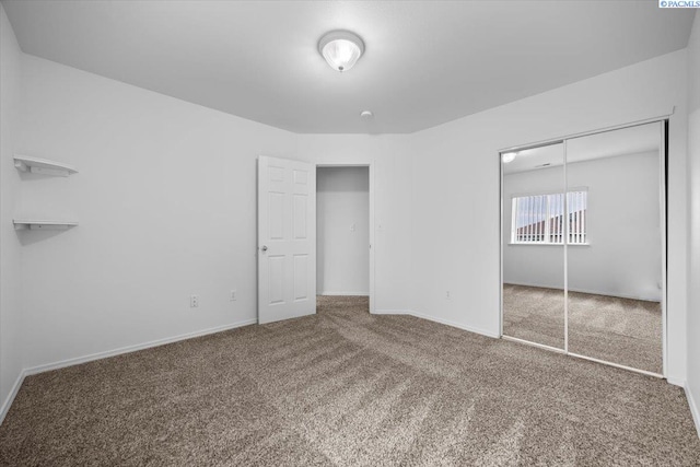 unfurnished bedroom featuring a closet and carpet