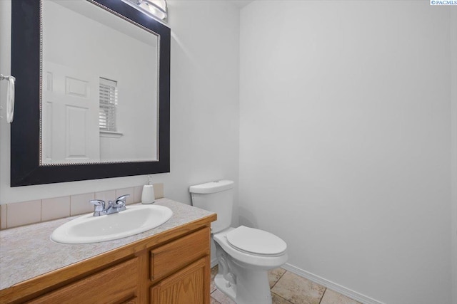 bathroom featuring vanity, tile patterned flooring, and toilet