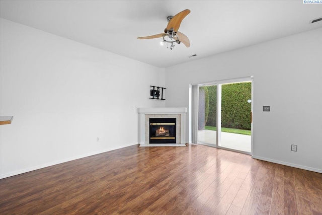 unfurnished living room featuring ceiling fan, a fireplace, and hardwood / wood-style floors