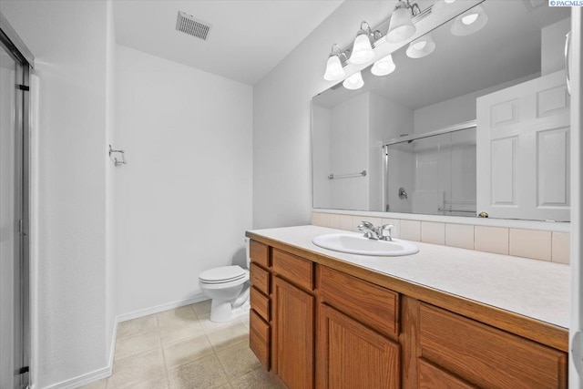 bathroom with vanity, toilet, and an enclosed shower