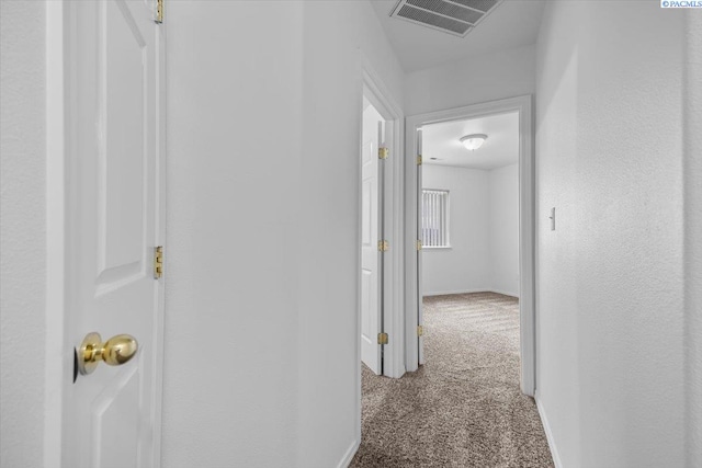 hallway with light colored carpet